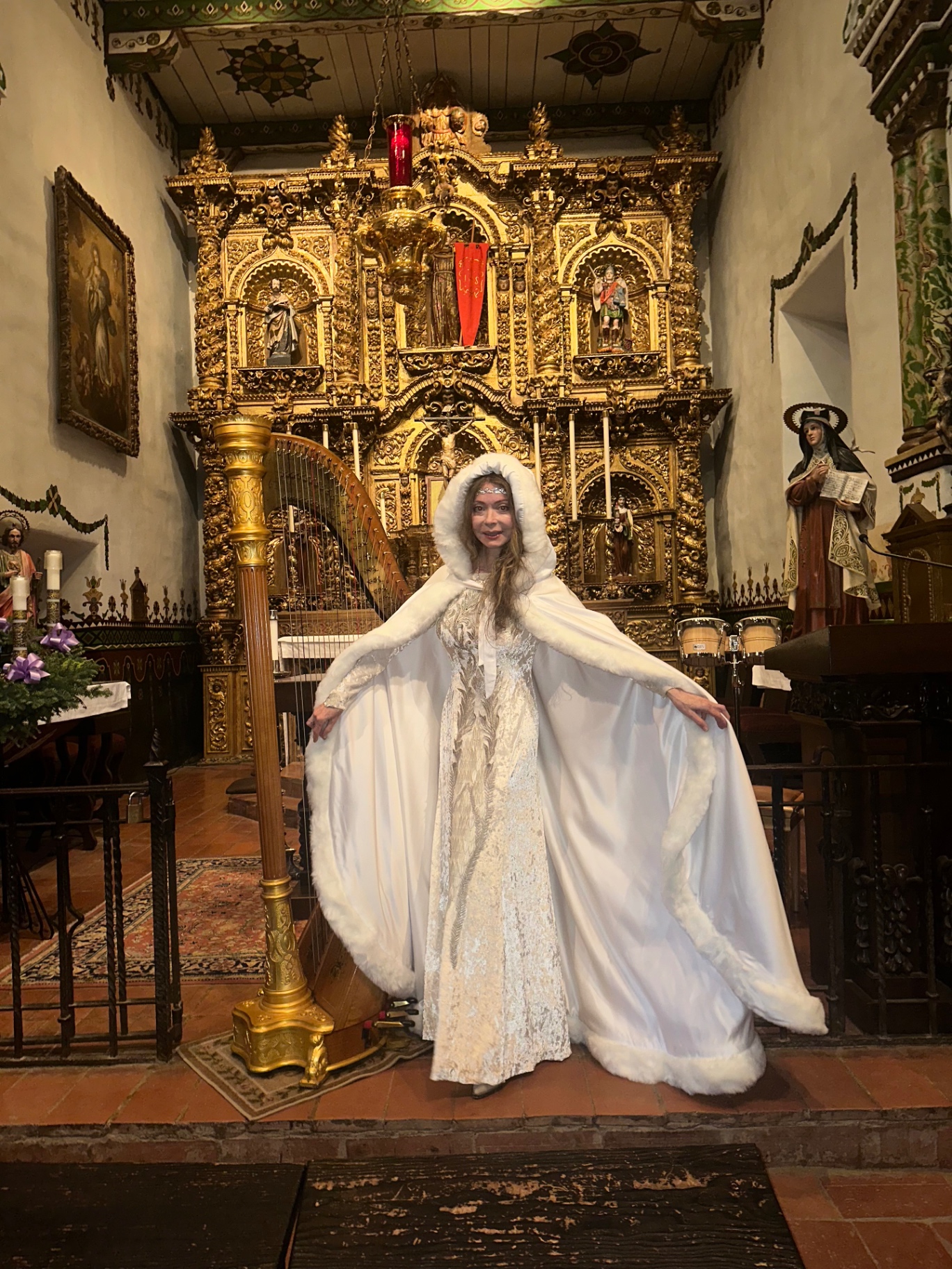 Candlelit mission chapel at Christmas with harp